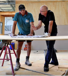 Photo of builders examining plans