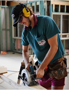Photo of builder cutting timber using a circular saw